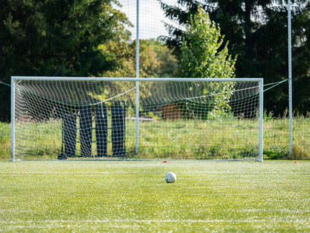 Selective focus. Ball is prepared for penalty kick. Gate is out of focus.の写真素材