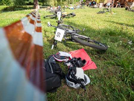 Radvanec, Czechia - 23th of August 2020. The Samuel XC triathlon event. Depot of the hobby race. Lots of mountainbikes laying in the grass before the startのeditorial素材