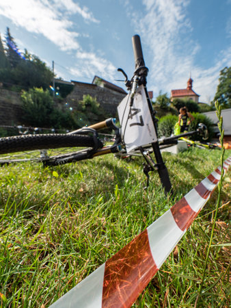 Radvanec, Czechia - 23th of August 2020. The Samuel XC triathlon event. Depo of the hobby race. Mountainbikes laying in the grass before the start in the race at Mountainbike Raceのeditorial素材