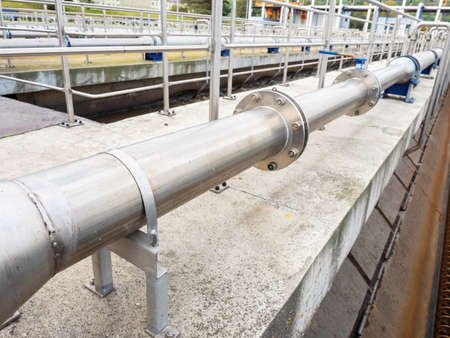 Chemical factory pool. Stainless steel pipes and pool in process. Industrial zone, industry...