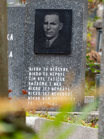 Aged man portrait engraved in gray granite with poem 24th of October 2020. Hronov, Czechia. Heloween walk inold town graveyardのeditorial素材