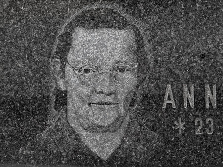 The tombstone dedicated to portraited Anna. 24th of October 2020. Hronov, Czechia. Portrait of a sad middle aged woman engraved into black graniteのeditorial素材