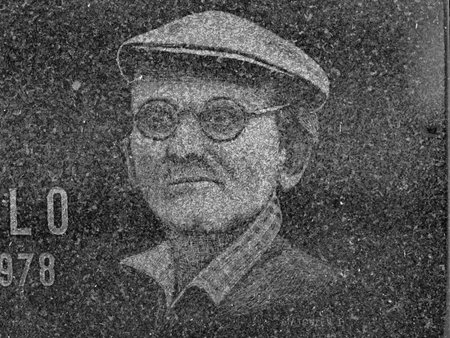 Aged man with hat and circle lennon glasses engraved into black granite stone. 24th of October 2020. Hronov, Czechia. Old town graveyard.のeditorial素材