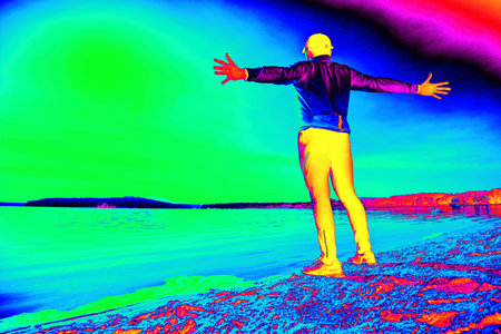 Middle age happy guy during morning exercising on the sandy beach over sea. Gamma radiation spectrum in simulator.の写真素材
