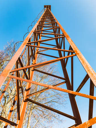 Old rusty watch tower. Old public loudspeakers broadcast on high tower with long distance tower.の写真素材