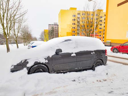Parked car trapped in huge snow cover. The car was covered with snow. Car under the snowの写真素材