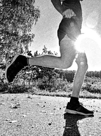 Athlete running and jumping on the trail for running. City park outdoor morning run. Black and white pencil sketch effectの写真素材