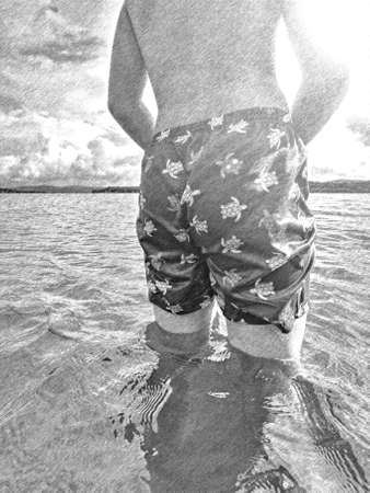 Boy in swimming shorts stay in cold water at coast. Teenager body in water. Black and white pencil sketch effectの写真素材