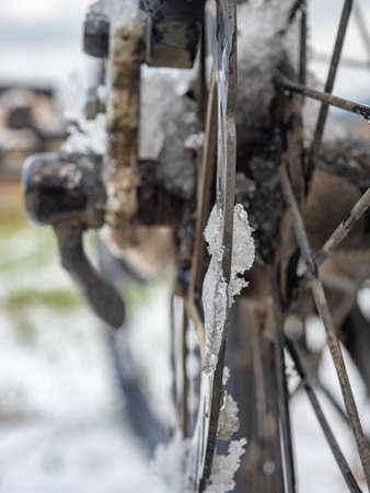 Dirty mountain bike disc brake with rest of snow and wet drops. Biking in winter landscape.の写真素材