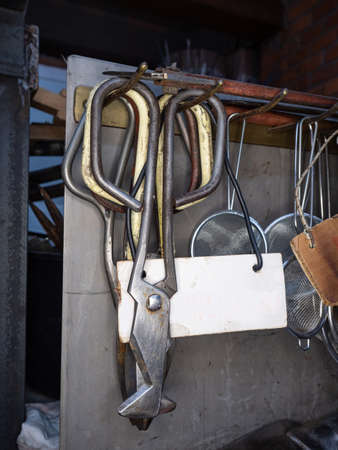 Rack of shaped Glassblowing Diamond Shear Scissors. Detailed glassblower manual tools in workshopの写真素材