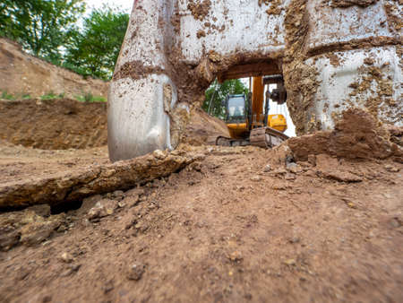 Scarry teeth of the excavator bucket. Heavy machinery in open quarry. Construction equipment.の写真素材