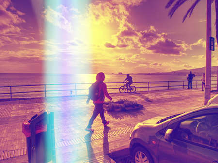Woman hiker with backpack on sunrise beach avenue, Abstract view.
