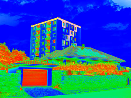 High flat house sticking up from residental district. Thermal color spectrum scale. Infra or thermography photoの写真素材