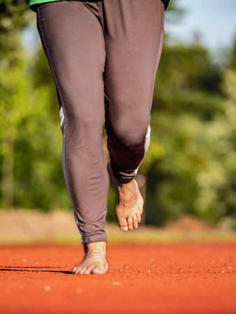 Running female bare feet in long leggings. Mature woman keep condition.の写真素材