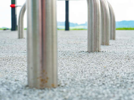 Chrome steel construction of children playground ends in safety rubbery tilled ground. Outdoor fitness placeの写真素材