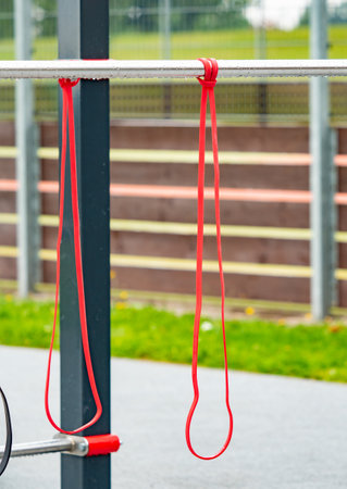 Workout gym with horizon bars with elastic exercise band. School outdoor gymの写真素材