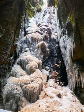 Frozen Large waterfall in Teplice Adrspach Rocks park during winter season. Eastern Bohemia, Czech Republicの写真素材