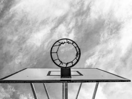 Basketball hoop and a cage with poor asphalt, sports background. BW, Black and white,の写真素材
