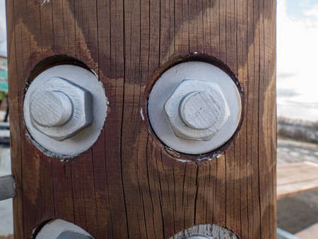 Screw and nut with metric thread. Wooden poles used in common construction.の写真素材