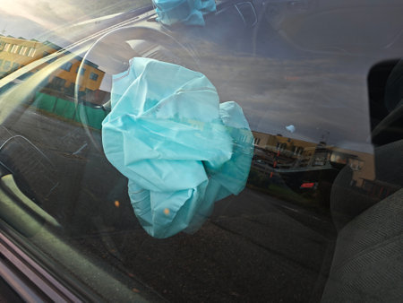 Both airbags exploded at a car accident. Car crash and airbags worked well. View through closed windowの写真素材