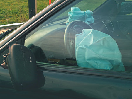 Both airbags exploded at a car accident. Car crash and airbags worked well. View through closed windowの写真素材