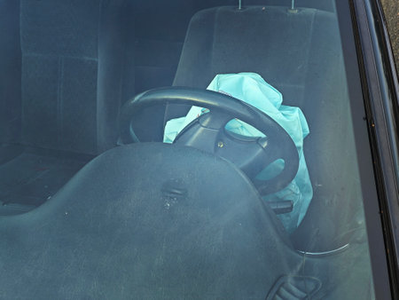 Exploded airbag in SUV car. Wrecked car with opened airbags after accidentの写真素材