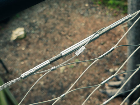 End tensioning joints on a modern wire fence. Anchor eye with thread and tensioning mechanism, safety equipmentの写真素材