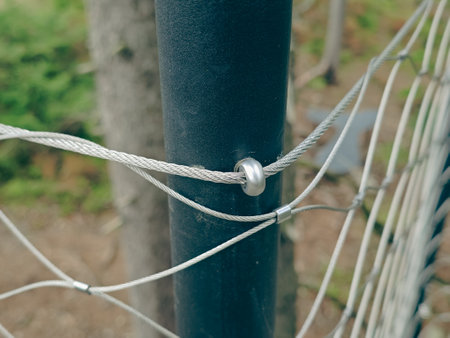 End tensioning joints on a modern wire fence. Anchor eye with thread and tensioning mechanism, safety equipmentの写真素材