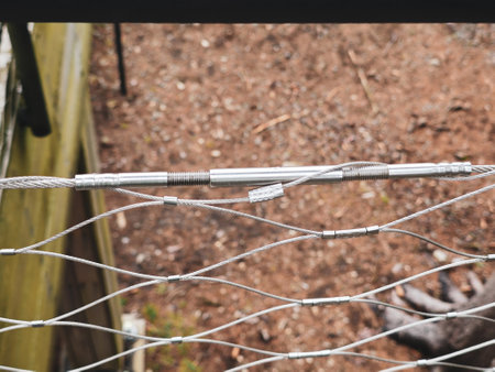 End tensioning joints on a modern wire fence. Anchor eye with thread and tensioning mechanism, safety equipmentの写真素材