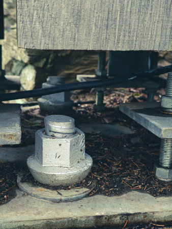 Reinforced concrete foundation with metal anchor bolts designed for the installation of metal columns. Foundation of warehouse on the construction siteの写真素材