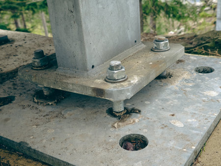 Reinforced concrete foundation with metal anchor bolts designed for the installation of metal columns. Foundation of warehouse on the construction siteの写真素材
