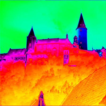 Old castle on the hill. Round view towers with spiky roof. Thermal camera photography, infrared scanの写真素材
