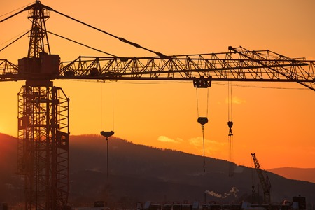 Construction of the building. Construction crane on the sunset backgroundの写真素材