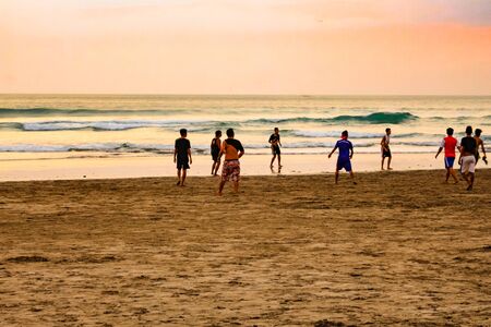 Bali, Indonesia - Oct 11, 2015: Sunset on the island of Bali, Indonesia. People walk on the beach.のeditorial素材