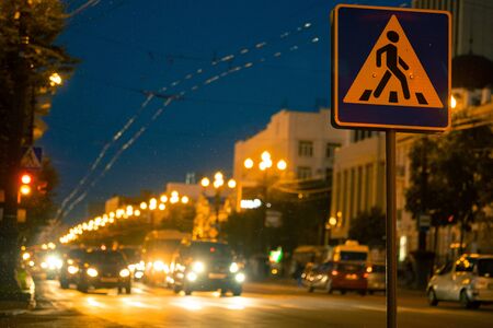 Khabarovsk, Russia - Aug 28, 2019: The streets of Khabarovsk in the evening. Cars go on the road. Sign pedestrian crossing.のeditorial素材