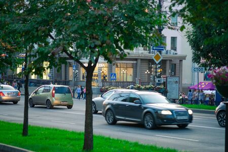 Khabarovsk, Russia - Aug 28, 2019: The streets of Khabarovsk in the evening. Cars go on the road. Central department store.のeditorial素材