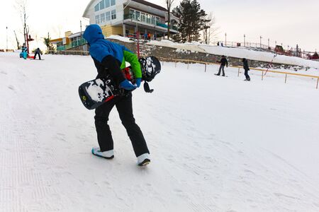 Khabarovsk, Russia - Dec 04, 2016: The girl instructor trains a teenager and a man snowboarding.のeditorial素材