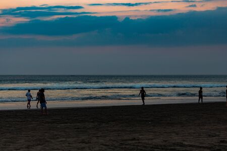 Bali, Indonesia - Oct 11, 2015: Sunset on the island of Bali, Indonesia. People walk on the beach.のeditorial素材