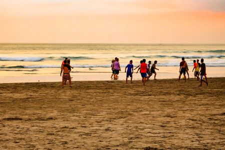 Sunset on the island of Bali, Indonesia. People walk on the beach.の写真素材