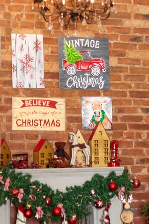 Gift boxes wrapped around the Christmas tree on the background. Cozy house is decorated to celebrate the New yearのeditorial素材