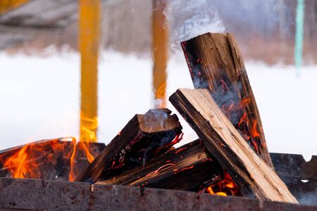 In the grill burning wood. Preparing coals for barbecueの写真素材