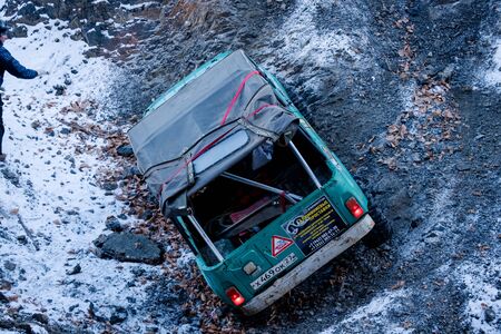 Khabarovsk, Russia - Nov 11, 2019: Jeep Suzuki Jimny overcomes obstacles in the forest.のeditorial素材