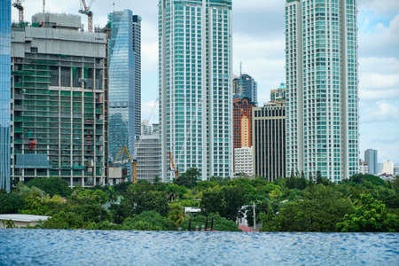 Manila, Philippines - Feb 02, 2020. View of the city of Manila from the pool of the luxury five-star Discovery Primea hotel. Sunny weather. Skyscrapers on the background.のeditorial素材