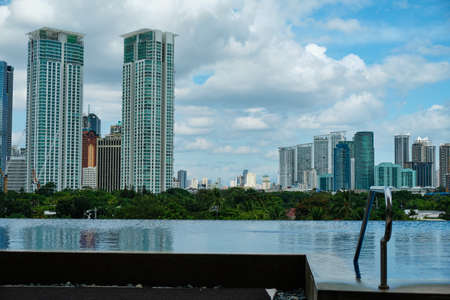 Manila, Philippines - Feb 02, 2020. View of the city of Manila from the pool of the luxury five-star Discovery Primea hotel. Sunny weather. Skyscrapers on the background.のeditorial素材