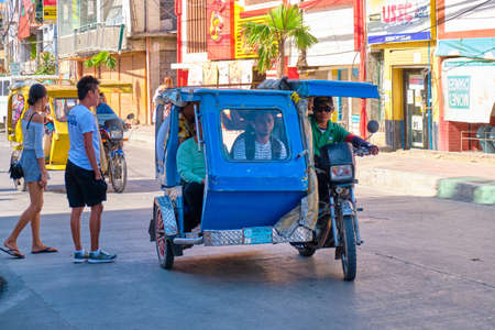 Boracay, Philippines - Jan 22, 2020: Public transport on Boracay island. The tricycle carries passengers.のeditorial素材