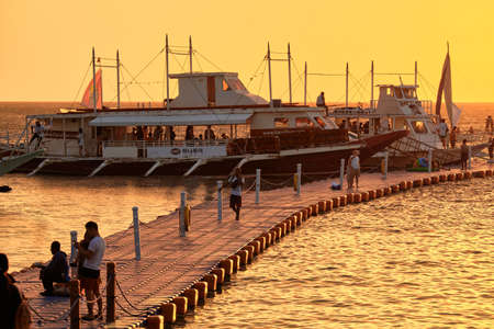 Sunset on the background of bottles standing on the bar. The sun passes through the bright glass of the bottles. Background image for the screensaver.のeditorial素材