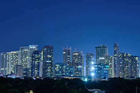 View of the night city of Manila from the pool of the luxury five-star Discovery Primea hotel. Sunny weather. Skyscrapers on the background.のeditorial素材