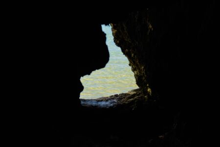 White beach of Boracay island. View through a tunnel in the rock to the sea. A few days before the...