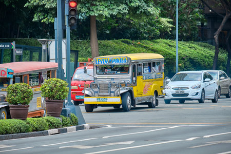 Manila, Philippines - Feb 02, 2020: Jeepneys on the roads of Manila. Former American military jeeps converted to public transportのeditorial素材