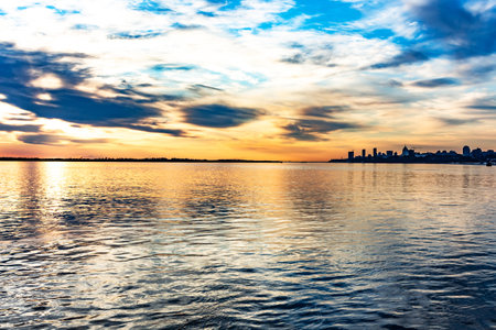 The sun went over the horizon of the Amur river in the city of Khabarovsk, forming magnificent colors in the sky. Beautiful colors in the sky, which are reflected in the water.の写真素材